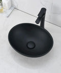 Oval Black Vessel Sink With Faucet And Drain Combo 16 By 13 Ceramic Bathroom Sink Above Counter Vessel Oval Porcelain Lavatory Vanity Art Basin Set Sleek Modern Design For Stylish Master Bath Or Powder Room, shown installed on marble countertop.