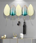 Heavy Duty Iron Wall Mounted Coat Hooks And Scarf Organizer With Sleek Geometric Lines holding keys and an umbrella against a gray wall.