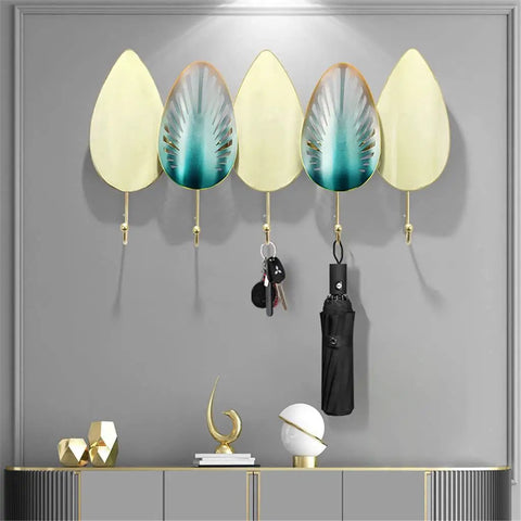 Heavy Duty Iron Wall Mounted Coat Hooks And Scarf Organizer With Sleek Geometric Lines holding keys and an umbrella against a gray wall.