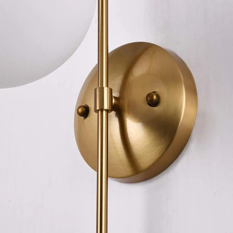 Gold Wall Sconce LED Globe Frosted Glass Shade Modern Bedside Light Fixture with brushed gold metal base.
