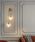 UPRENXIAO Modern Wall Sconce Linear Curved Design Up Down Lighting Ambient(Gold) with two vertical lamps on a wall.
