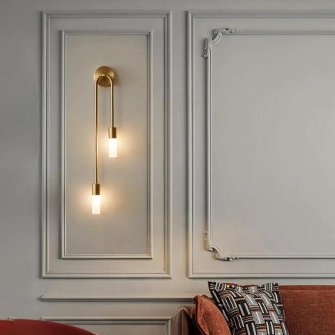 UPRENXIAO Modern Wall Sconce Linear Curved Design Up Down Lighting Ambient(Gold) with two vertical lamps on a wall.