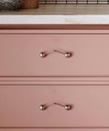 One Pack 5 Inch Titanium Silver Cabinet Handles Ball Tip Pulls With Polished Solid Brass Core And Premium Titanium Silver Finish installed on pink drawers