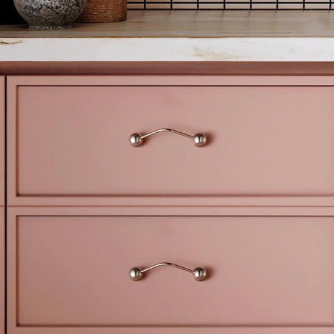 One Pack 5 Inch Titanium Silver Cabinet Handles Ball Tip Pulls With Polished Solid Brass Core And Premium Titanium Silver Finish installed on pink drawers