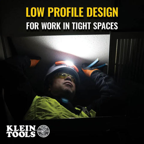 Person working in ceiling space wearing rechargeable LED wide beam headlamp with hard hat mounts for work, 770 lumens.