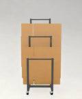 Rock Solid Metal Rolling Cart For Cardboard Storage And Art Drying Rack With Smooth Casters No Sweat Setup Built Tough For Garage Shop Warehouse Organization displaying stacked cardboard boxes.