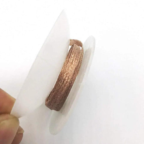 Spool of Pro Grade Desoldering Braid Solder Wick for BGA Rework, 1.5mm Copper Wire, in hand for electronics repair.