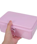 Hand holding a Badass Pink Metal Toolbox With Reliable Locking Latch Built Tough For Your Sweet Ride And Garage Grinds.