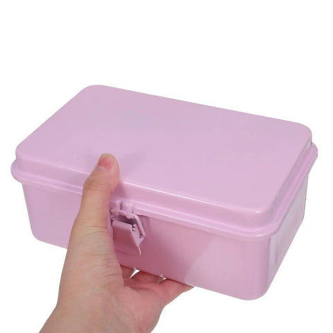 Hand holding a Badass Pink Metal Toolbox With Reliable Locking Latch Built Tough For Your Sweet Ride And Garage Grinds.