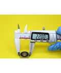 Measuring a 608 Hybrid Ceramic Ball Bearing size 22mm with calipers on a yellow background for accurate dimensions.