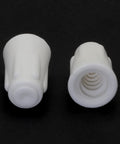 Two white ceramic wire twist caps, medium size, interior threading visible (close-up view)