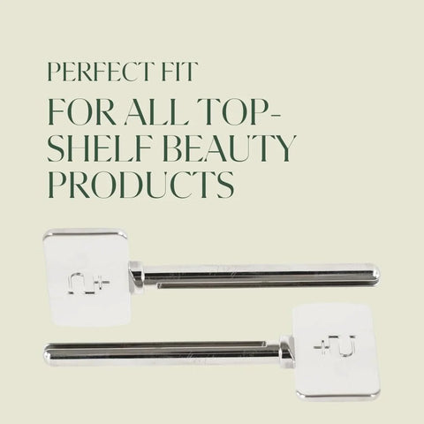 Two chrome metal toothpaste tube squeezers with white plastic end caps.