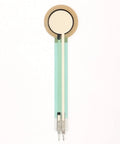 Front view of FSR402 force sensing resistor with round beige sensing disk and green flexible film leads
