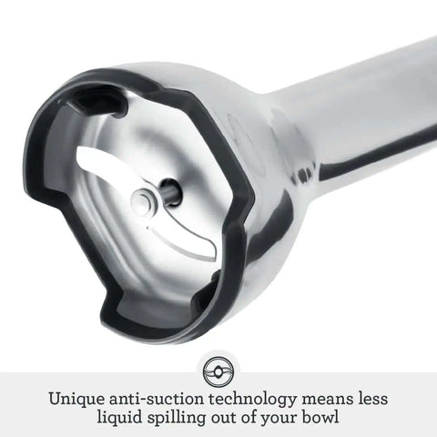 Close-up of Control Grip Immersion Blender's blade and anti-suction tech, perfect for less splatter. Level Up Your Kitchen Routine With The Control Grip Immersion Blender Anti Suction Tech Stops Splatters While You Blend Includes 42 Oz Jug Plus Whisk For Silky Smooth Soups And Creamy Mixes With Comfortable Trigger Handle In Brushed Stainless Steel.