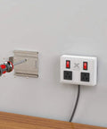 Wall Mounted Extension Cord With Surge Protector And Individual Circuit Breakers, Heavy Duty Power Strip For Home Office And Laundry Room, White Finish, Easy Install Kit Included shown half installed on wall.