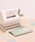 Mini die-cut machine with cutting mat and heart shapes, part of Mini Die Set For Scrapbooking And Card Making - 7 Scalloped Circle Dies