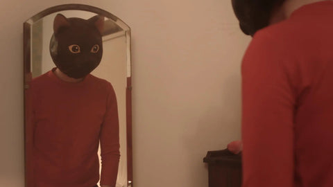Man wearing a cat mask in front of a mirror, from Cat Sick Blues Blu Ray Region Free Edition A Dark Gripping Gritty Indie Drama.