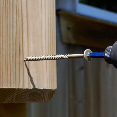 Close-up of a 50 Pack 5/16 Inch X 4 Inch T40 Star Drive Structural Screw for Decking being installed into wood.
