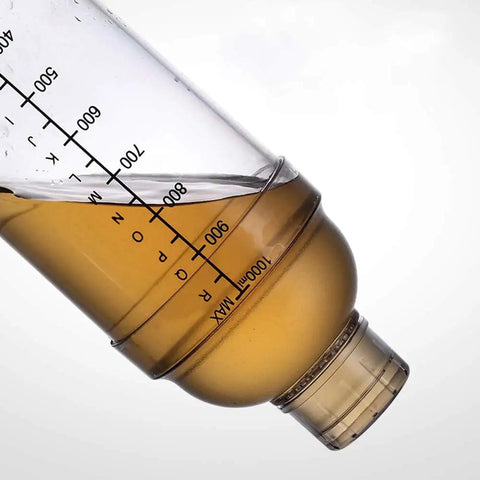 Close-up of the Clear Plastic Cocktail Shaker With Measurement Scale 33 Oz Handheld Drink Mixer showing scale and liquid content