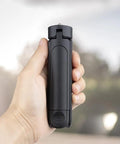 Person holding Pocket Sized 2 In 1 Mini Tripod Desk Stand And Handheld Grip, Ultra Lightweight 2 Oz, One Quarter Inch Mount