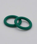 Two green O-rings from Number 10 Cup And O Ring Set For WP 17 18 26 And WP 9 20 TIG Welding Torches 15 Piece Replacement Kit