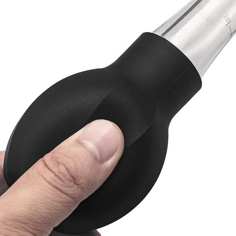 Close-up of hand holding Game-Changing Silicone Turkey Baster With Easy To Use Bulb Syringe Tool for Juicy Turkeys