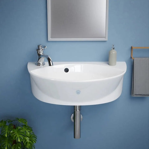 Small Wall Mounted Bathroom Sink 17 Inch White Ceramic Oval Basin With Porcelain Coated Finish Floating Wall Hung Design Overflow Single Faucet Hole On Left Side Space Saving Go To Modern Fixture For Small Bathrooms Easy Install installed on blue wall with mirror above.