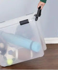 Clear Plastic Storage Bin With Locking Lid Rolling Wheels Weather Tight Seal And Clear Design Provides Lockdown Protection From Moisture Dust And Debris Plus Secure Grip Handles being pulled by a person.