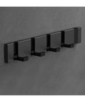 Badass Heavy Duty Wall Mounted Coat Hooks Rack With Five Sturdy Aluminum Pegs on a concrete wall for hanging winter coats and hats.
