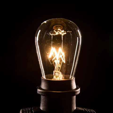Close-up of a glowing bulb from the Beefed-Up 100 Foot Outdoor Commercial String Lights With E26 Suspended Sockets, Weatherproof Vintage Exterior Lighting, 50 S14 11W Bulbs, 100 Ft Run For Patio And Backyard Parties, Built To Last.