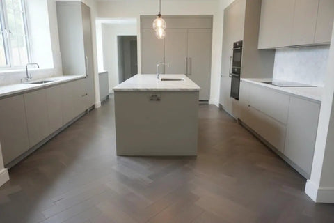 Pro Level Reactive Water Based Interior Wood Stain Delivers A Legit Gray Brown Weathered Patina On Beams Walls And Furniture Zero Voc Formula For Smooth Application Heavy Duty 55 Gallon Drum Ready in modern kitchen with light gray cabinets and marble countertop.