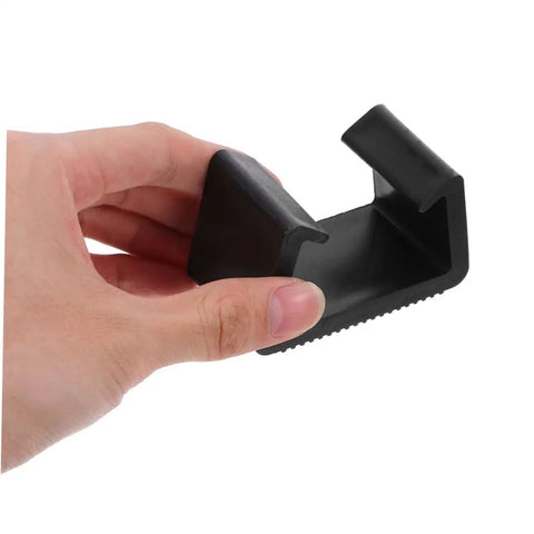 Person holding black plastic clip from Outdoor Furniture Clips Set For Sectional Sofas And Patio Use Secure Couch Clamps.