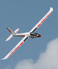 Swift 2100 RC Glider For Beginners Starter Friendly 82.7 Inch Wingspan PNP Kit With Folding Prop in flight against blue sky.