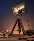 Dope Vintage Industrial Tripod Table Lamp With Teak Wood Base, Brown Brass Finish, Rustic Gold Accent, on wooden surface