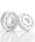 Two white 608 zirconia full-ceramic ball bearings shown side-by-side