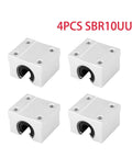 Four white aluminum SBR10UU open-type linear bearing blocks with top mounting holes.