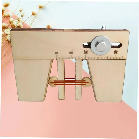 Wooden Mooring Tool For Sailing Model Kits Handy Lightweight Fixation Device displayed diagonally on pink surface.