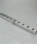 Long rectangular aluminum block with multiple threaded holes, visible as Aluminum Pneumatic Fitting Manifold Block 2 Way Splitter For Air Water Gas Oil Lines One Quarter Inch BSP 20x20mm DIY Friendly Pro Grade Garage Ready Quick Disconnect.