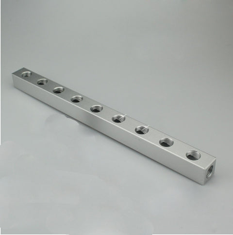 Long rectangular aluminum block with multiple threaded holes, visible as Aluminum Pneumatic Fitting Manifold Block 2 Way Splitter For Air Water Gas Oil Lines One Quarter Inch BSP 20x20mm DIY Friendly Pro Grade Garage Ready Quick Disconnect.