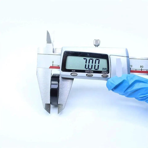 High Temperature Thin Section Full Ball Bearings 17x30x7mm measured with caliper showing 7.00mm size for heavy duty machinery.
