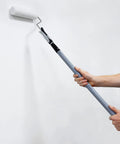 Person using 10 Piece Paint Roller Kit With 9 Inch Rollers Tray Extendable Poles Angled Brush Extra Roller Covers Can Opener Stir Bar