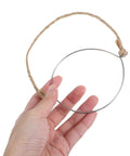 Hand holding a metal jar handle with wire hanger and hemp rope. 5 Pcs Metal Jar Handles And Wire Hangers For Mason Jars With Universal Hemp Rope.