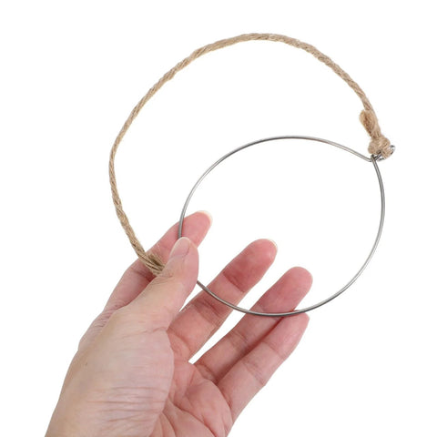 Hand holding a metal jar handle with wire hanger and hemp rope. 5 Pcs Metal Jar Handles And Wire Hangers For Mason Jars With Universal Hemp Rope.