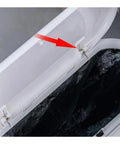 Close-up of a silver stainless steel 3-coil torsion spring on a garbage can lid hinge.