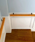Hold On Tight Heavy Duty Stair Handrail And Hallway Safety Rail with wood grip and wrought iron brackets on stairs.