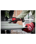 M12 Fuel 16 Gauge Variable Speed Nibbler used on metal sheet, demonstrating fast, clean cuts in a construction setting.
