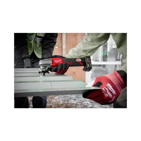 M12 Fuel 16 Gauge Variable Speed Nibbler used on metal sheet, demonstrating fast, clean cuts in a construction setting.