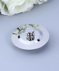 Bathtub Stopper for 40-45mm Holes Flat Cover Stainless Steel resting on a gray surface with floral background