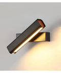 Sleek black metal swivel wall sconce LED lighting for accent glow, perfect for bedroom, living room, or hallways.