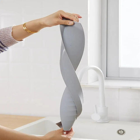 Person holding Silicone Sink Splash Guard Baffle For Splash-Proof Protection Heightening Countertop Edge Guard Light Grey Kitchen Accessory